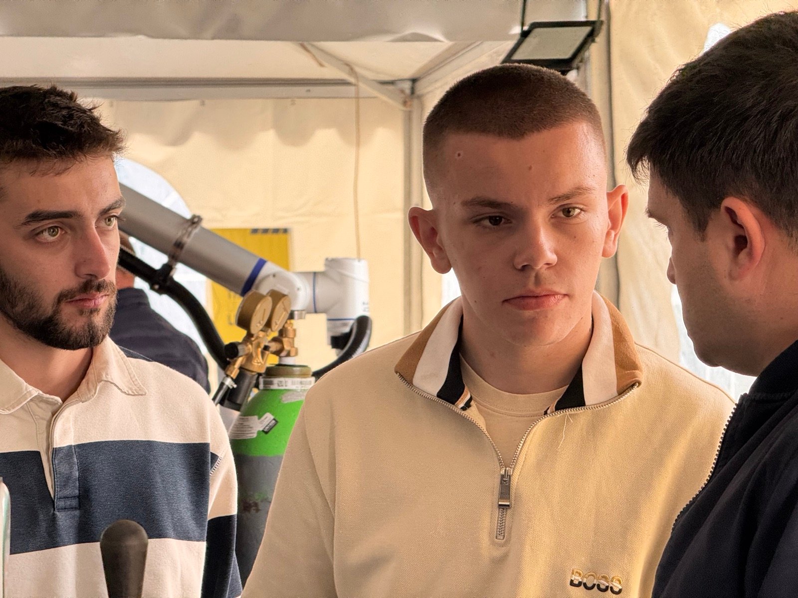Attendees discussing Makweld Robotix technology at Octoberfest